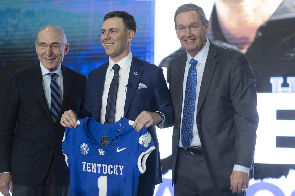 New Kentucky head football coach Will Stein, center, poses for a picture with UK President Eli Capilouto, left, and UK Athletics Director Mitch Barnhart following a media conference where Stein was introduced at Nutter Field House on Wednesday.