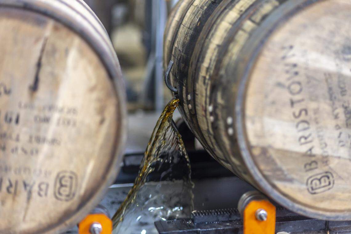 Aged bourbon is emptied from a barrel at Bardstown Bourbon Company in Bardstown, Ky., on Wednesday, Nov. 19, 2025.
