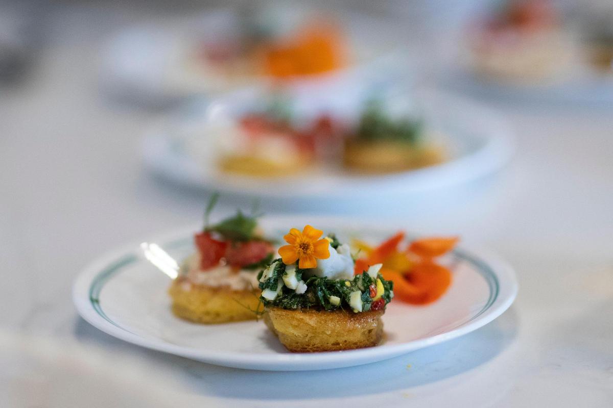 For journalists, chef Ouita Michel prepared and served Silver Dollar Hoe Cakes with nasturtium salsa verde and lump crab, and a cheese and tomato purslane salad.