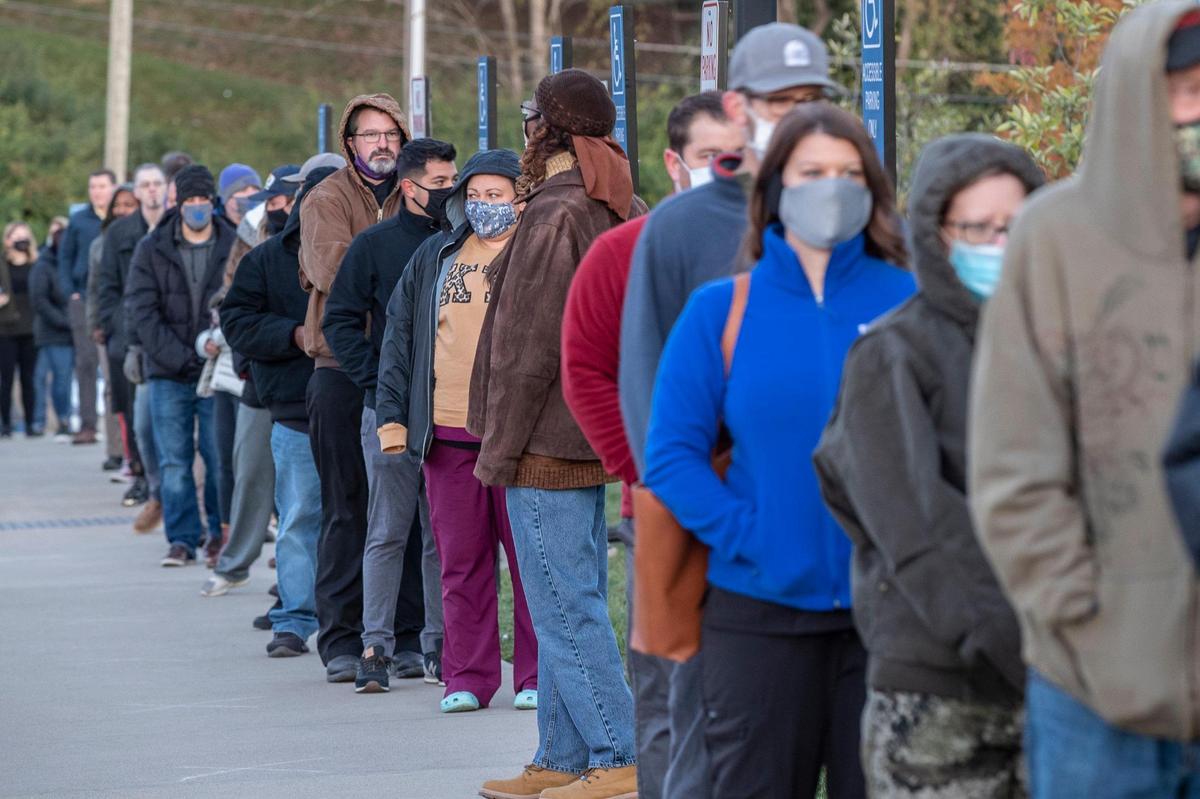 Fayette County residents wait in line to vote Tuesday outside the Lexington Senior Center.