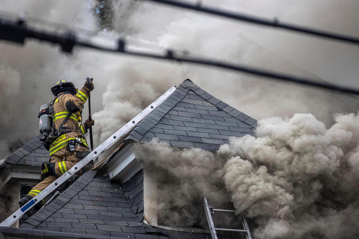 Members of the Lexington Fire Department respond to a structure fire on Aylesford Place in Lexington, Ky., on Monday, June 20, 2022.