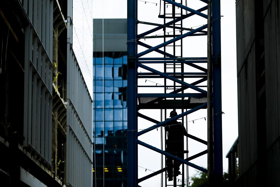 Ed Dangler, currently of Lancaster, makes the 275 foot climb by ladder each day to the cab of a tower crane above City Center Tuesday in downtown Lexington. Dangler has been operating tower cranes since 1993 and jokes that the climb is the hardest part of the job.