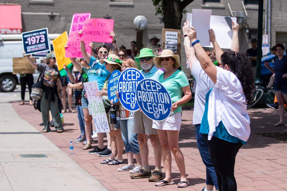 Protesters cheer and gather outside the courthouse during the Rise Up 4 Abortion Rights protest in downtown Lexington, Ky., Saturday, May 14, 2022.