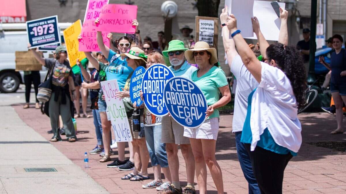 Protesters cheer and gather outside the courthouse during the Rise Up 4 Abortion Rights protest in downtown Lexington, Ky., Saturday, May 14, 2022.