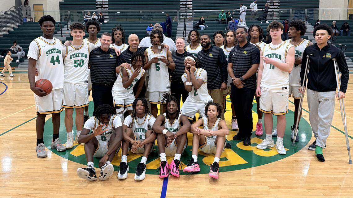 Bryan Station players and coaches posed for a team photo in celebration of senior point guard Amari Owens (5) breaking the program’s school record for career points against Sayre on Sunday at Bryan Station High School.