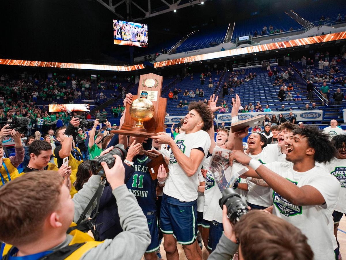 Great Crossing Malachi Moreno (24) hoisted the championship trophy after Great Crossings beat Bowling Green in the UK Healthcare Boys’ Basketball Sweet 16 state tournament championship game at Rupp Arena in Lexington, Ky., on Saturday, March 29, 2025.
