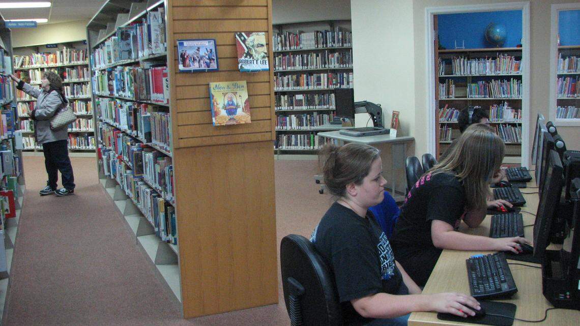 Laverna Watkins browsed the shelves while Michelle Robinson, center, used computers with her children at the Breathitt County Public Library in 2011.