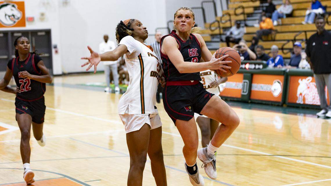 George Rogers Clark’s Kennedy Stamper, right, drove in for a layup against Frederick Douglass’ Jaelee Knowles during their game in the Douglass Holiday Showcase at The Farm on Dec. 20. The Cards and Broncos have each made this season’s Girls’ Sweet 16.