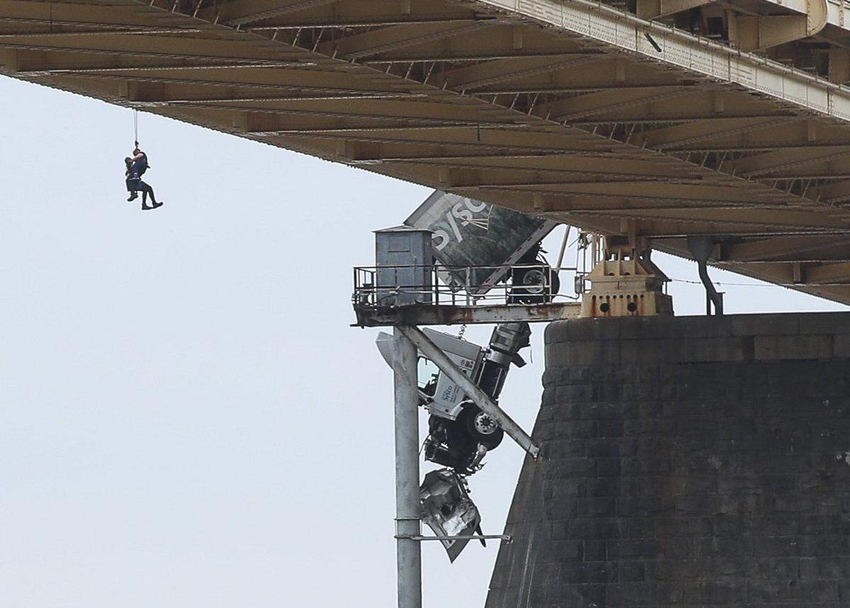 March 1, 2024; Louisville, KY, USA; Rescuers work to get a driver out of the cab of a tractor trailer on the Clark Memorial (Second Street) Bridge. Mandatory Credit: Matt Stone-USA TODAY NETWORK  