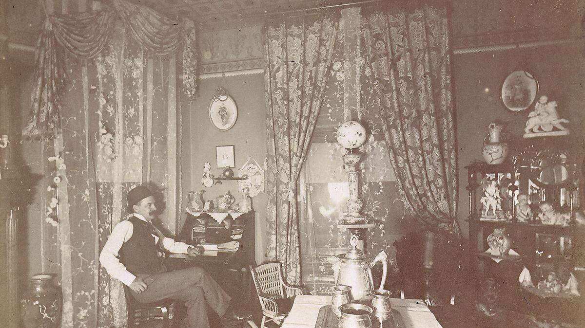 59 Megowan St., Belle Brezing's third and most famous bordello, 1889-1917; Brezing occupied the house until her death in 1940, interior; Brezing's private parlor; the seated man is Billy Mabon, Brezing's lover until his death in 1917. Photo date listed as 1895. Photo Courtesy of the Belle Brezing Photographic Collection 1868 - 1983, UK Special Collections      