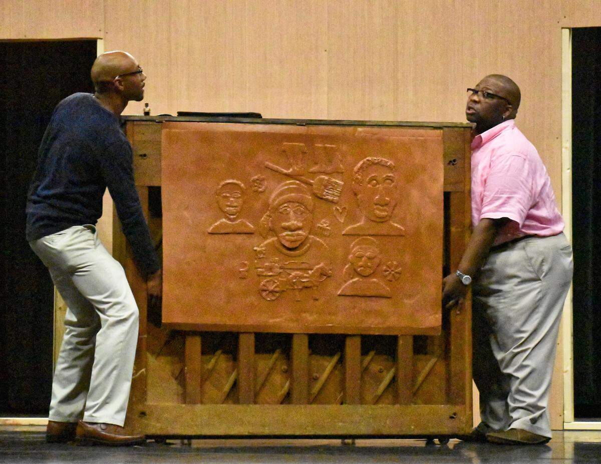 Emanuel Thurman (left, as Lymon) and Damon Greene (as Boy Willie) rehearsing a scene from “The Piano Lesson,” about a brother and sister fighting over a family heirloom. The artwork for the carvings on the piano were done by of Message’s co-founders, Frank X. Walker, a Lexington poet and former Kentucky Poet Laureate.