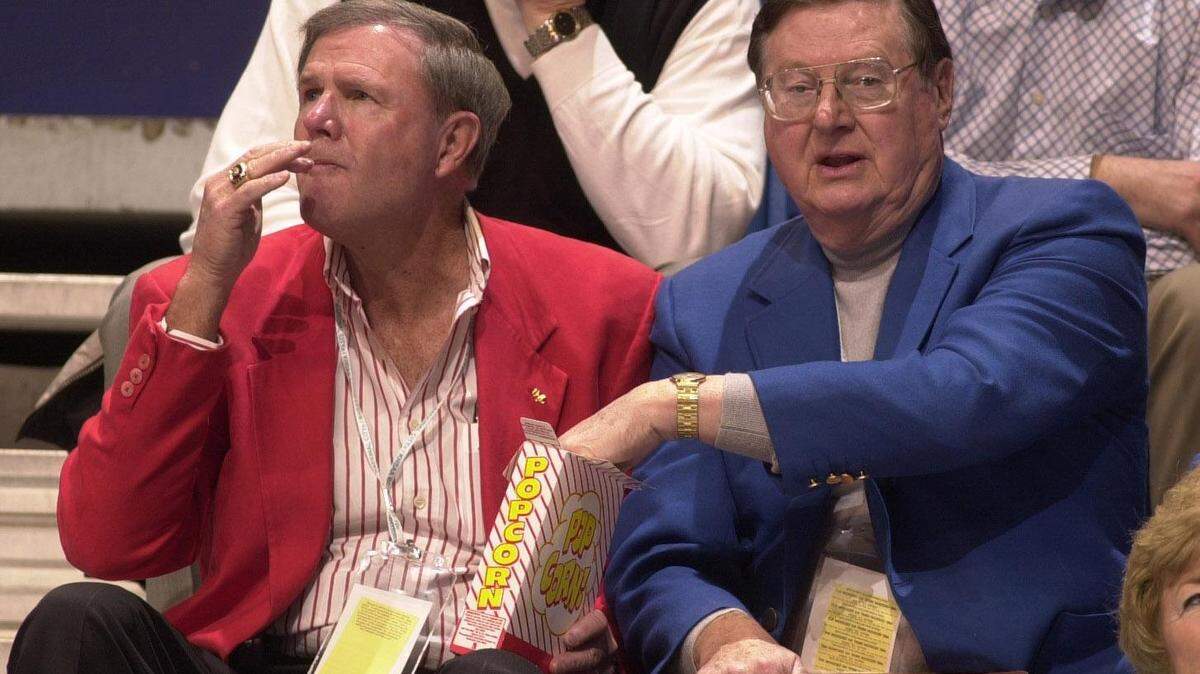 Former Kentucky coach Joe B. Hall helped himself to some popcorn from the box held by former Louisville coach Denny Crum as they watched Covington Catholic beat Carlisle County 63-40 in the first round of the 2004 Boys’ Sweet 16 state tournament at Rupp Arena. This photo, taken by former Herald-Leader photographer David Stephenson, became an enduring symbol of the unlikely friendship between the one-time archrival coaches.