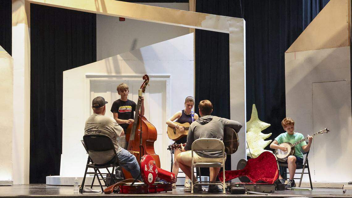 Bluegrass University students take class on the stage of the Leeds Center For The Arts, Monday, Sept. 15, in Winchester, Ky. The curriculum, designed for students aged 11-18, focuses on advanced skills like playing in a band and harmonizing, rather than basic instrument lessons.