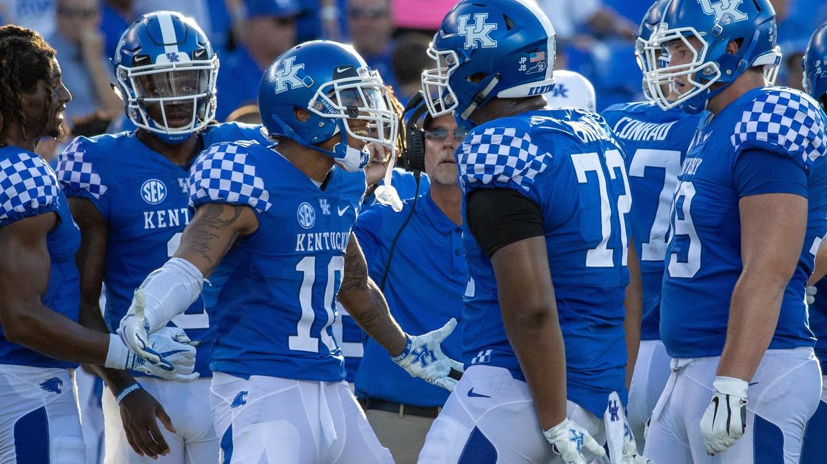 Kentucky left tackle E.J. Price (72) interacted during a timeout with running back A.J. Rose, who ran for two touchdowns for the Cats against Central Michigan. Price was ecstatic to be back on the field after sitting for the past two seasons.