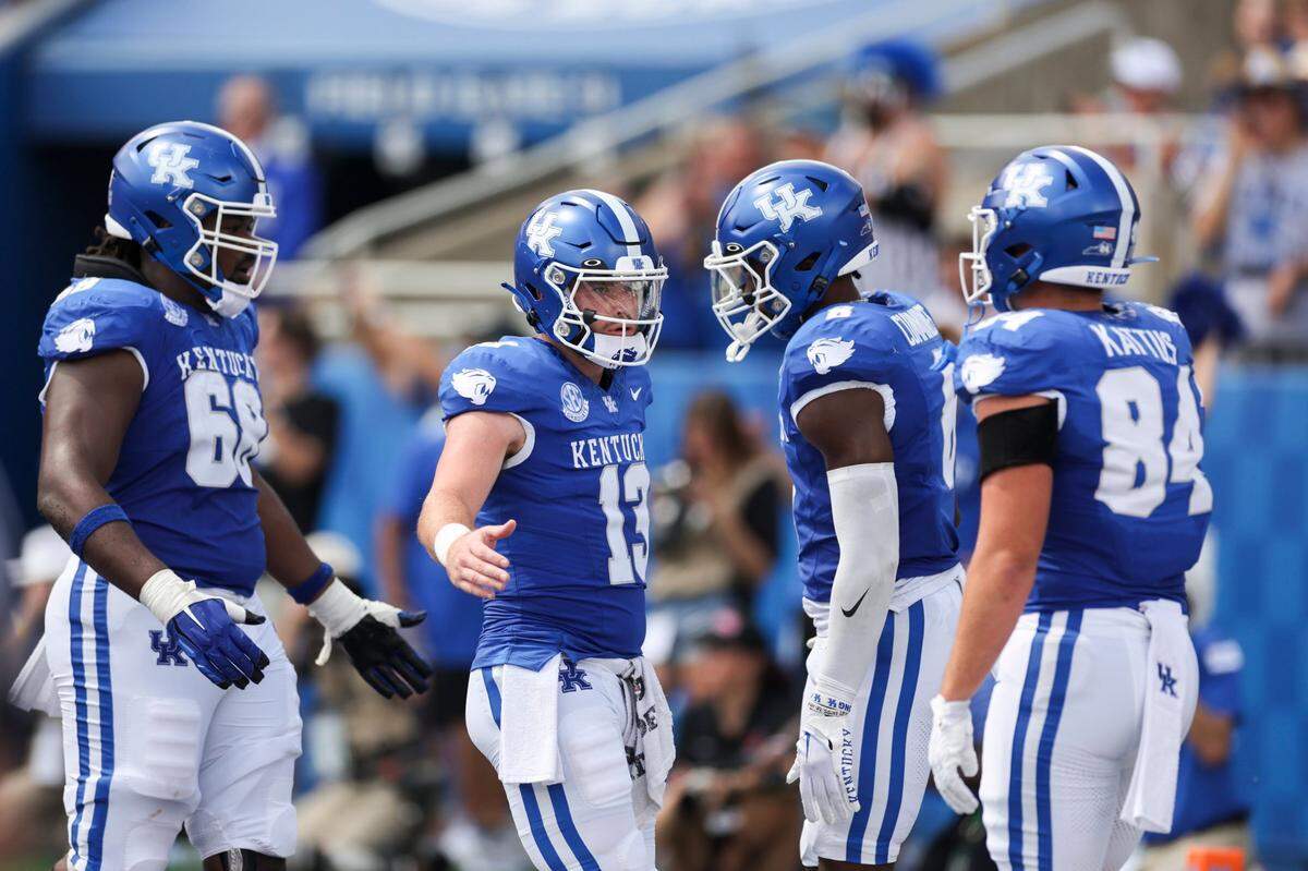 Kentucky quarterback Devin Leary (13) celebrates his first touchdown pass as a Wildcat during Saturday’s game against Ball State.