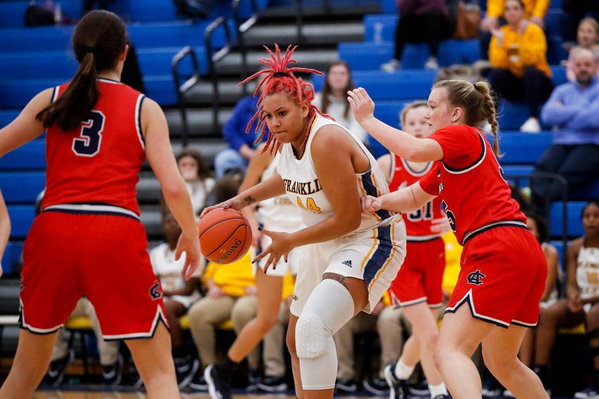 Franklin County’s Jhaven Meade (44) dribbles the ball against Anderson County’s Faith Hyatt (55) during a game at Franklin County High School in Frankfort on Jan. 19, 2023.
