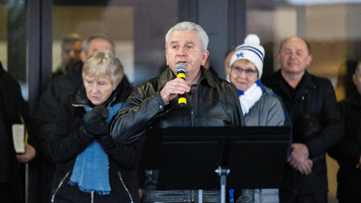 Victor Kalinyuk, a member of Ukrainian Pentecostal Church on Brannon Road, sings into the mic during a public vigil to show support for Ukraine, February 25, 2022.