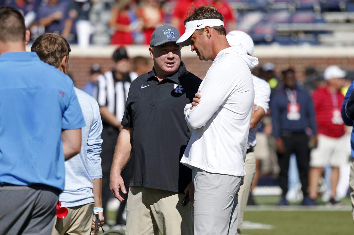 Kentucky coach Mark Stoops, left, spoke with Mississippi coach Lane Kiffin prior to UK’s 22-19 loss at Ole Miss in 2022. Stoops is 0-3 as Cats coach against the Rebels with the three defeats coming by a combined seven points.