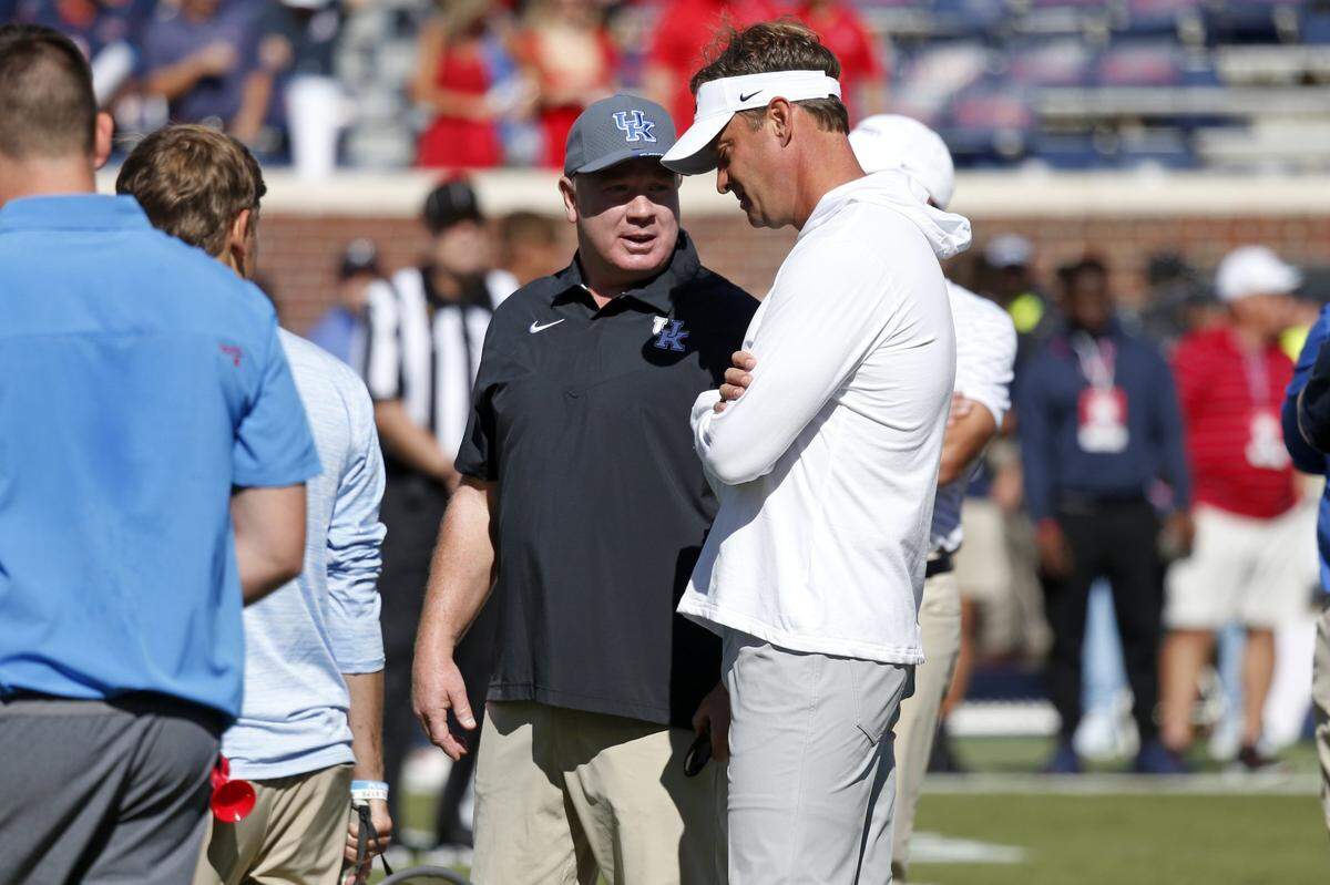 Kentucky coach Mark Stoops, left, spoke with Mississippi coach Lane Kiffin prior to UK’s 22-19 loss at Ole Miss in 2022. Stoops is 0-3 as Cats coach against the Rebels with the three defeats coming by a combined seven points.