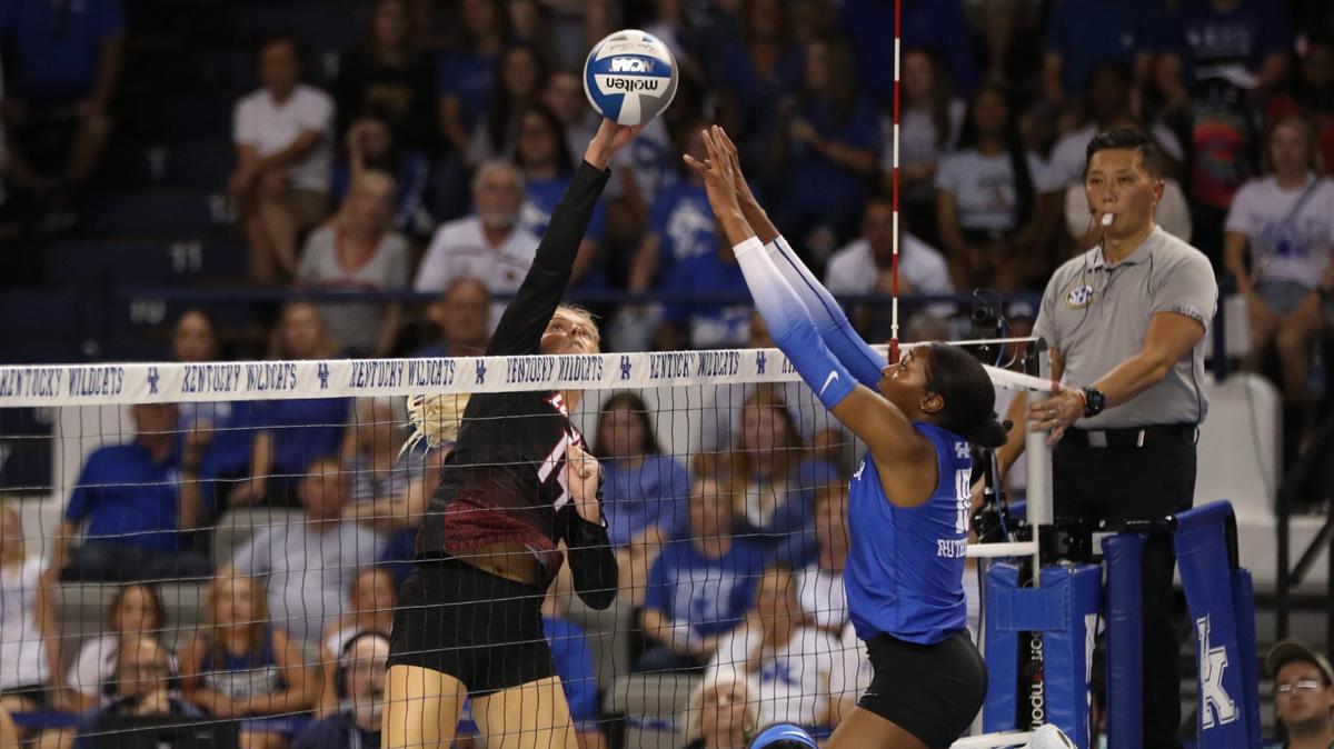 Kentucky junior Reagan Rutherford tries to block a kill attempt by Louisville during Wednesday night’s match between UK and U of L at Memorial Coliseum in Lexington.