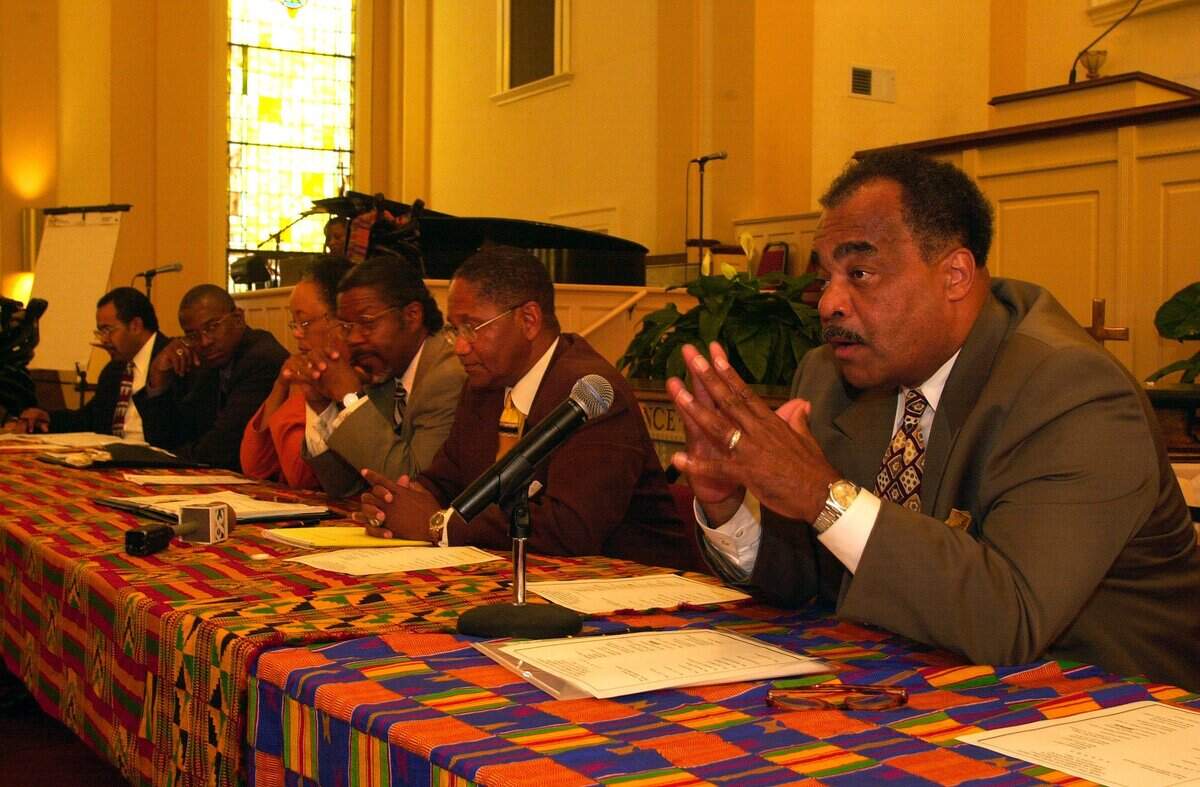 Rev. Bob Brown, at right, representing DADS Program and Adopt-A-School, speaks at a meeting about efforts in the community to draw attention to racial disparities. The forum, “For The Good Of The Children,” was held July 19, 2001 at Shiloh Baptist Church on East 5th Street in Lexington, Kentucky. Others on the panel were, from far left to right, Rev. Joseph Owens, Rev. Richard Gaines, Beverly Watts and P.G. Peeples.