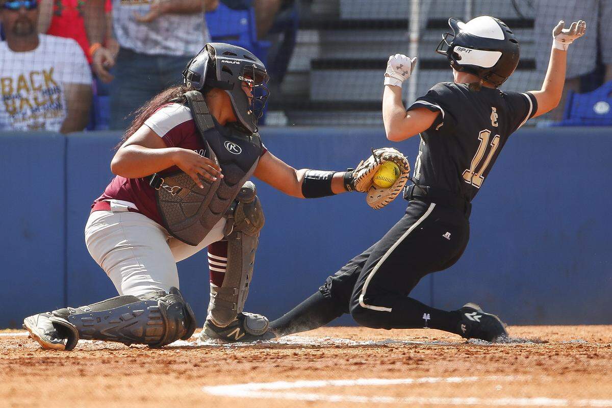 Clay County’s Ellie Finley (11) slides into home past /Madisonville-North Hopkins’ Mykayla Spurlin (17) during the KHSAA State Softball Tournament quarterfinals at John Cropp Stadium in Lexington, Ky., Friday, June 14, 2019. Clay County beats Madisonville North-Hardin 4-2. 
