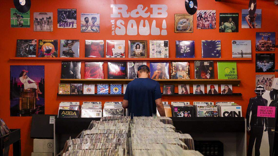 Walker Martin looks through records at CD Central on South Limestone near the UK campus, Wednesday, August. 27, 2025 in Lexington, Ky. “I’m glad there they’re keeping it a record store,” said Martin of the new owners. Martin said he would shop the local CD and record store when he was a UK student in 2006 and stated again when he moved back to Lexington.