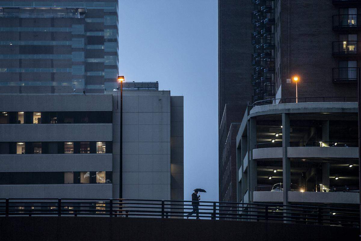 A pedestrian walks across the South Martin Luther King Boulevard overpass Jan. 3 in downtown Lexington. The Downtown Lexington Management District acts similar to a homeowners association. It collects taxes and spend those taxes in downtown to help keep the area clean, safe and welcoming.
