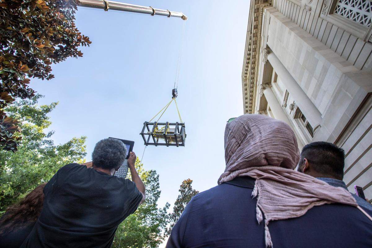 Workers use a crane to remove the Jefferson Davis statue from the Kentucky state Capitol in Frankfort, Ky., on Saturday, June 13, 2020.