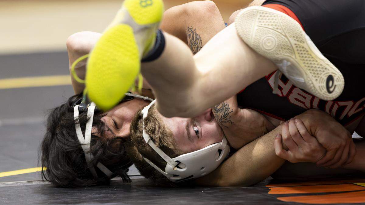 Paul Laurence Dunbar’s Drake Wimsatt, right, endured a tough early going against Great Crossing’s Miguel Fransisco, but later got a pin for the 126 title at the KHSAA Boys/Co-ed Region 6 Wrestling Championships at Harrison County High School in Cynthiana on Saturday.
