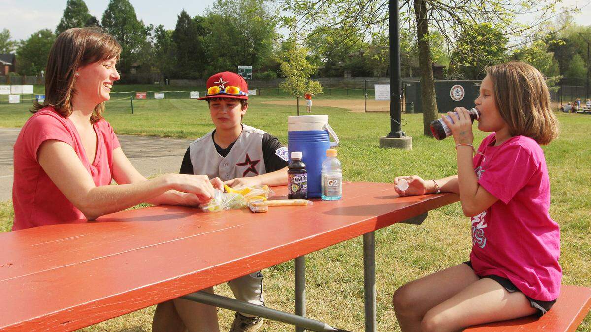Jill Kindy, a registered dietician, makes sure to provide healthy snacks for son Drew, who plays basketball and baseball, and daughter Lauren, who cheers and swims. The family was at Ecton Park recently for one of Drew's baseball games.   
