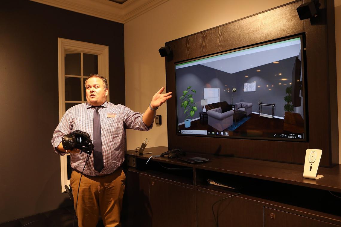 Justin Kilgore, Macy’s sales manager, held a VR headset as he demonstrated virtual shopping in the furniture department, part of the upgrades to the Fayette Mall store resulting from the company’s Growth50 strategy. Photo by Matt Goins