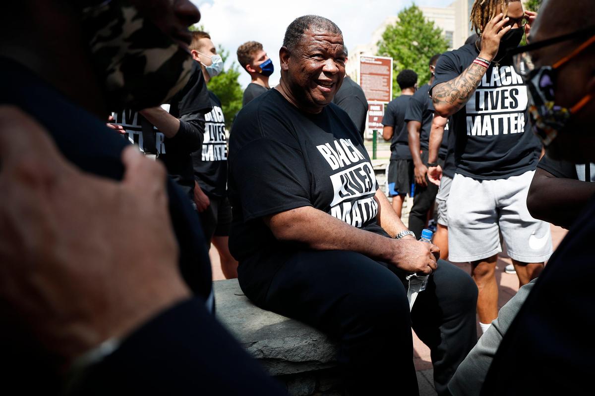 University of Kentucky associate head football coach Vince Marrow laughed with players at Courthouse Place during a march supporting Black Lives Matter through downtown Lexington on Friday.