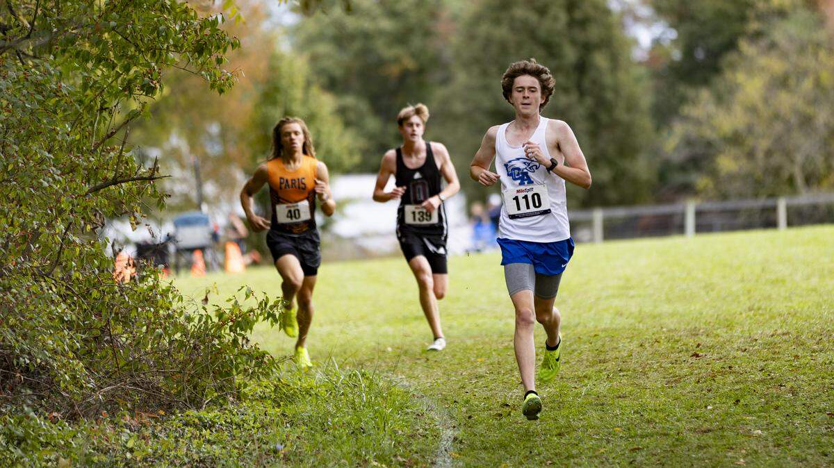 Lexington Christian’s Kyle Stickel begins to build a gap over Paris’ Bruce Hayden, left, and Owen County’s Tyler Cammack about midway through the boys Class A, 5th Region Cross Country Championships at Shelby County Cross Country Course in Shelbyville on Saturday.