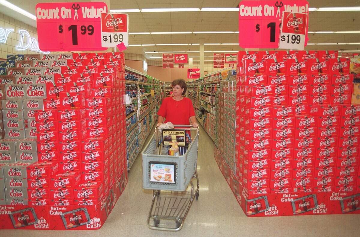 Dudley Robertson made her way down an aisle past a Coke display at the Tates Creek Road Kroger, Aug. 11, 1998 in Lexington Ky.