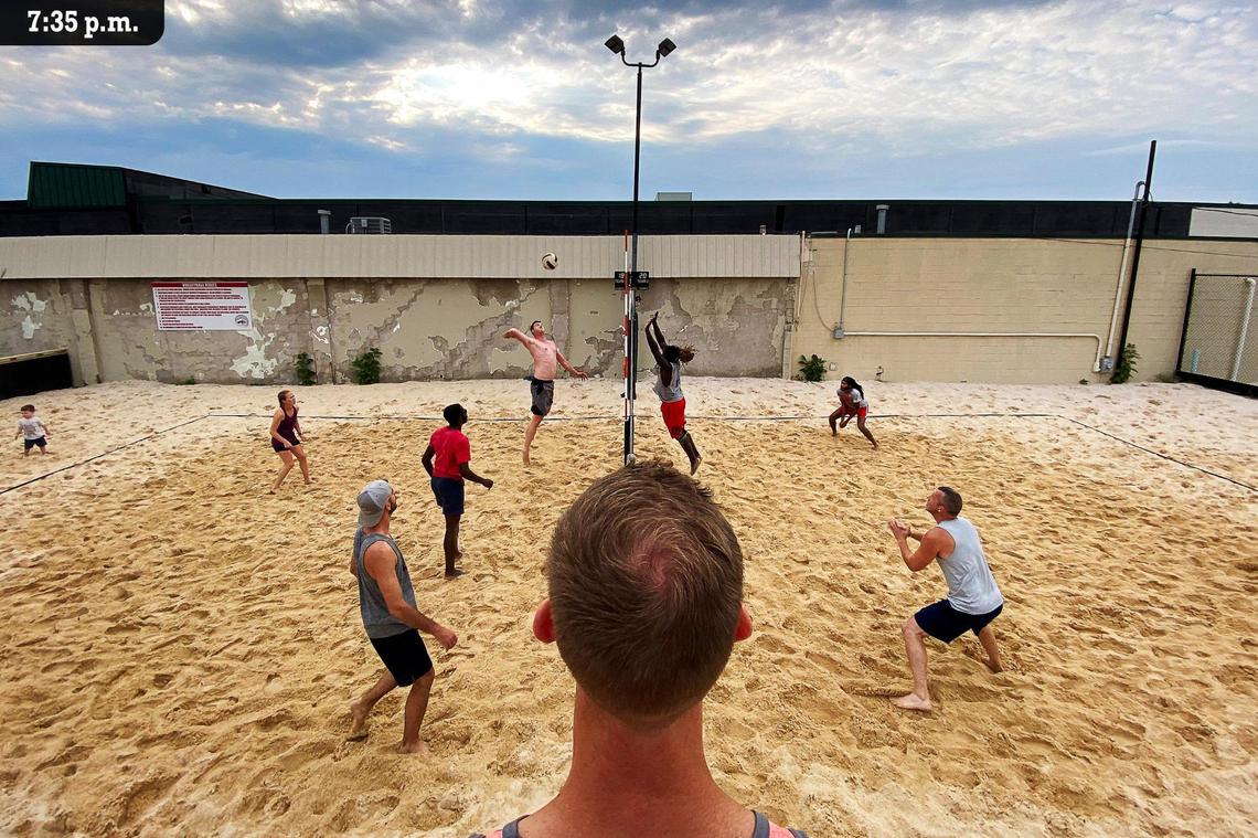 Referee Jordan St. Clair watches as Laderemey Fielder goes up to block Woodrow Friend during a Friday, July 9, 2021 beach volleyball league match at Marikka’s Restaurant & Bier Stube in Lexington.
