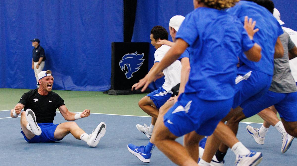 Millen Hurrion’s teammates run up to him in celebration after Hurrion won his singles match in Kentucky’s NCAA Tournament match against Wake Forest on Saturday.