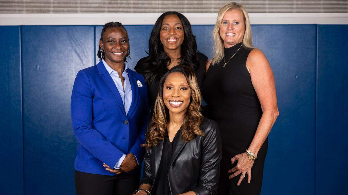 Kentucky women’s basketball head coach Kyra Elzy (front row, center) hired former Western Kentucky University star and Kentucky Miss Basketball Crystal Kelly as an assistant coach this offseason. Kelly (back row, center) joins a UK staff that also includes Niya Butts, left, and Jen Hoover, right.