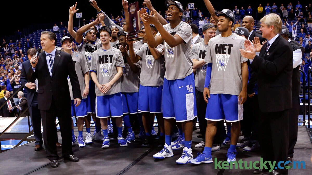 The University of Kentucky team with the NCAA Midwest Region trophy after they defeated the University of Michigan in Lucas Oil Stadium in Indianapolis, In., Sunday, March 30, 2014. This is second half NCAA Midwest Regional finals action. UK won 75-72 to advance to the Final Four. Photo by Charles Bertram | Staff 