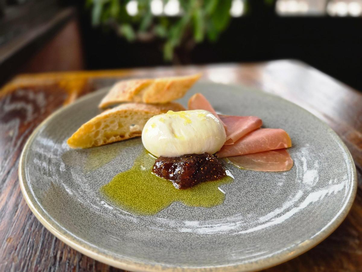 The Burrata appetizer ($19) at Crust has a sizable drop of creamy Italian cheese with prosciutto, fig jam, arugula, grilled ciabatta bread and extra virgin olive oil.