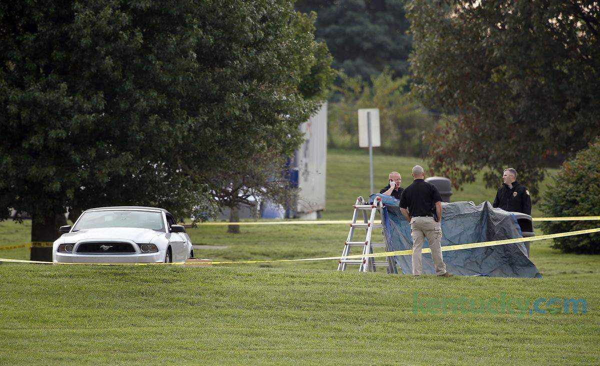 Investigators work at the Interstate 75 rest area where a Scott County deputy was shot and critically injured in an exchange of gunfire with a fugitive from Florida.