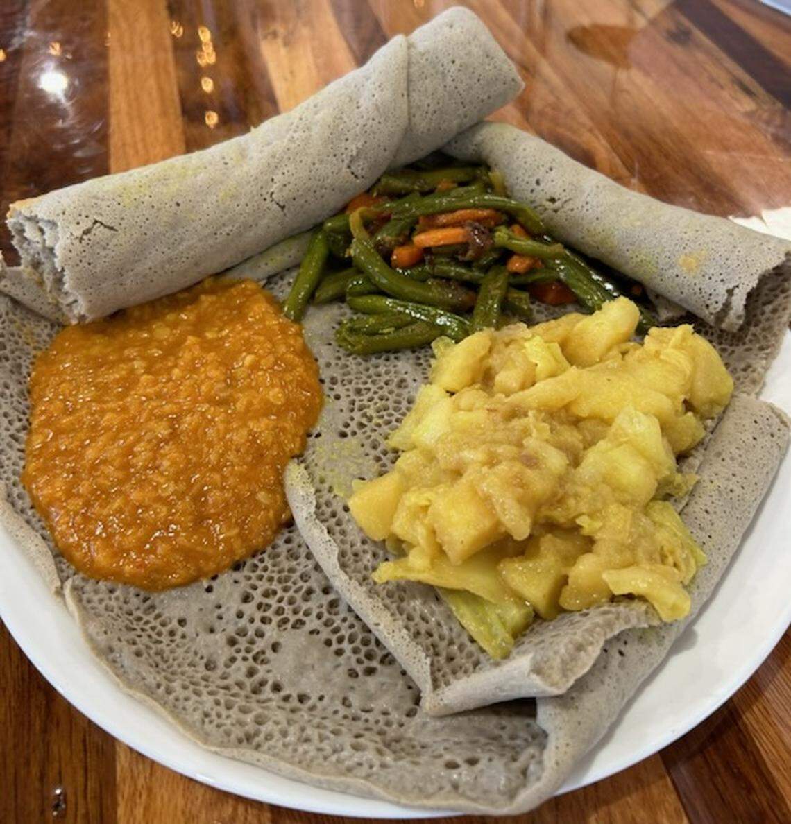 The menu at Ethiopian Family Kitchen includes items served on injera bread including red lentils, green beans and carrots and cabbage and potatoes cooked with Ethiopian spices.