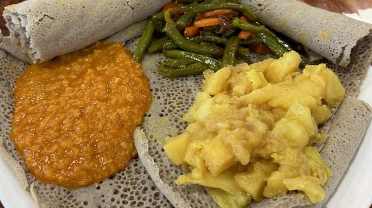 The menu at Ethiopian Family Kitchen includes items served on injera bread including red lentils, green beans and carrots and cabbage and potatoes cooked with Ethiopian spices.