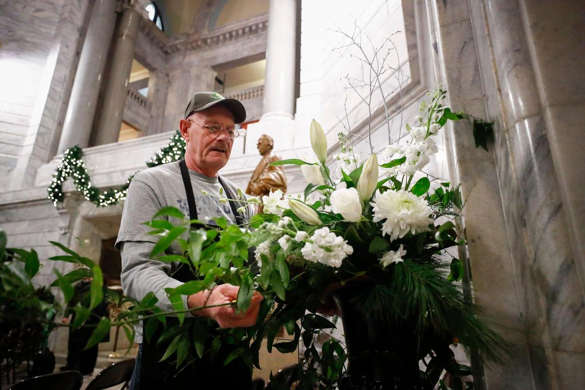 Dave Campbell, of Lexington, Ky., arranges flowers in the Capitol Rotunda as part of inauguration preparation in the state Capitol in Frankfort, Ky., Monday, Dec. 9, 2019.