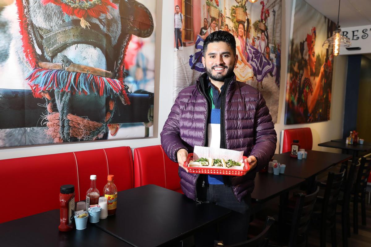 Owner Christopher Bravo with steak tacos in the dining room at El Cid at 304 S. Limestone, the former home of Sav’s Grill.