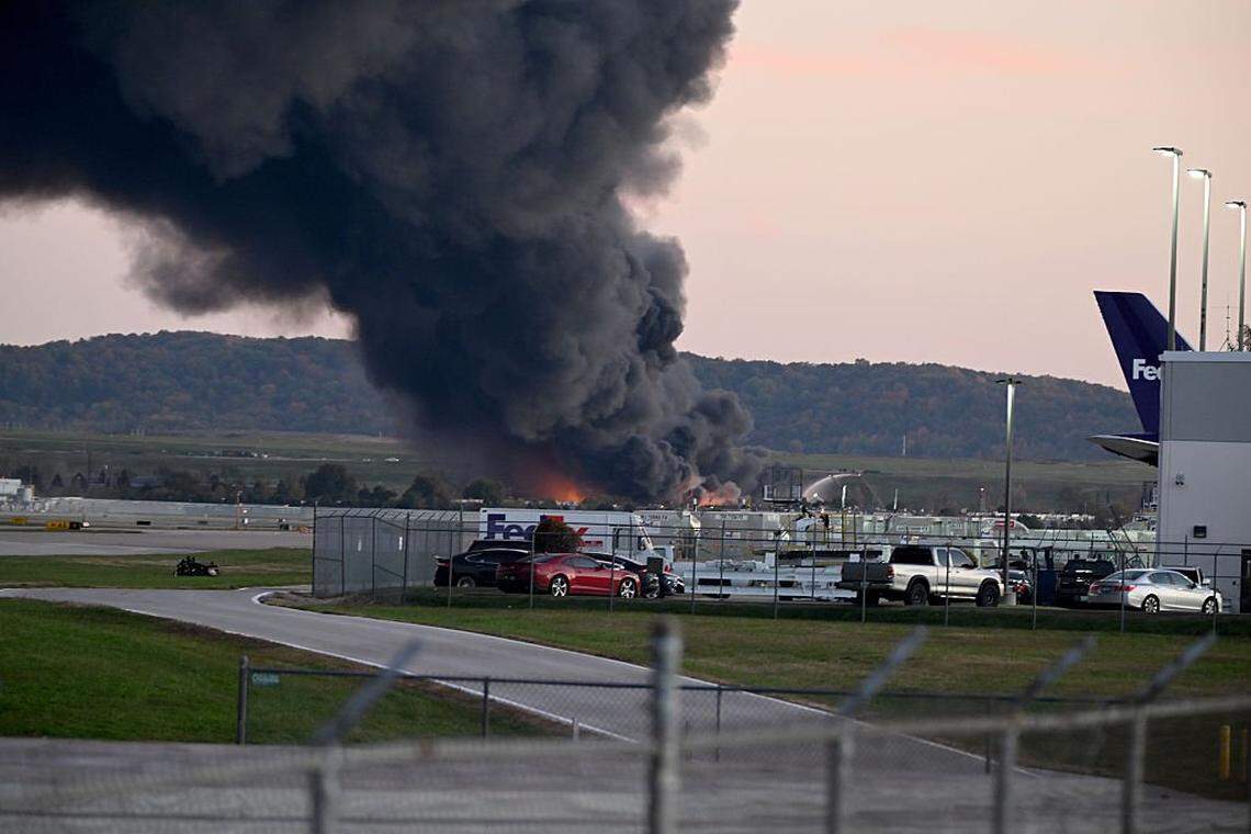 LOUISVILLE, KENTUCKY - NOVEMBER 04: Fire and smoke mark where a UPS cargo plane crashed near Louisville Muhammad Ali International Airport on November 04, 2025 in Louisville, Kentucky. The fully fueled plane crashed shortly after takeoff with a shelter-in-place order issued for within 5 miles of the airport. (Photo by Stephen Cohen/Getty Images)