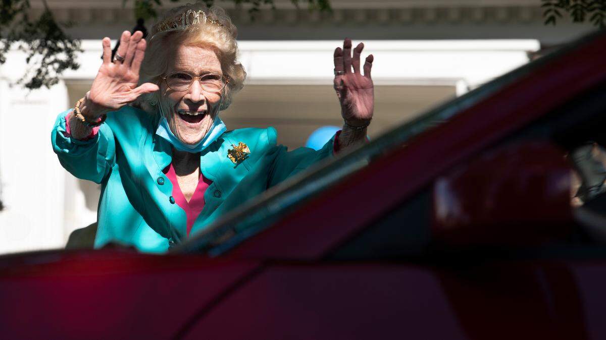 Helen Evans waves to a car during a drive through celebration for her on her 100th birthday on Thursday, June 11. Evans, a graduate of UK, served in the military during World War Two, and helped create the Friends of KET organization after the war.