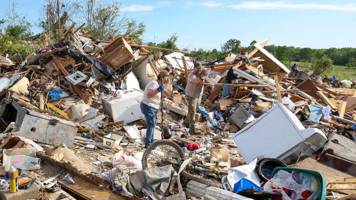 David and Edwina Wilson clean up and take items to be saved from their Sunshine Hills home, Sunday, May 18, 2025 in London, Ky. Their home was destroyed when a deadly tornado ripped through the neighborhood two days earlier. They stayed in the home during the storm. “The walls just fell down around them,” Joe Wilson, their son said.