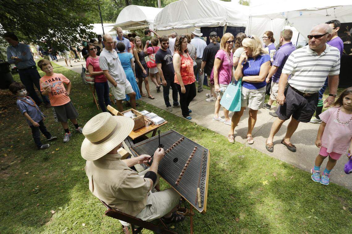 Kyle Meadows of Cold Spring played a hammer dulcimer for fair goers during the 39th Annual Woodland Arts Fair at Woodland Park in 2014.