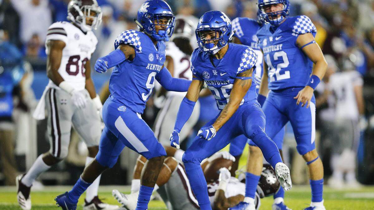 Kentucky’s Zach Johnson (28) celebrated a big hit on Mississippi State punt returner Dontavian Lee during the first half at Kroger Field on Saturday night.
